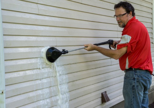 Man perfrorming soft-brush Siding Cleaning in Peoria IL