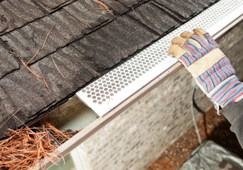 A man fitting Gutter Protection in East Peoria IL to a home's gutters